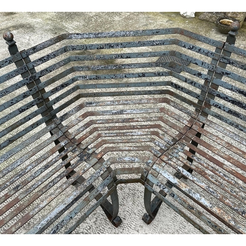 20 - An impressive well weathered iron strapwork three-section corner bench, overall 160 by 160cm.