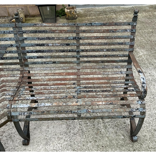 20 - An impressive well weathered iron strapwork three-section corner bench, overall 160 by 160cm.
