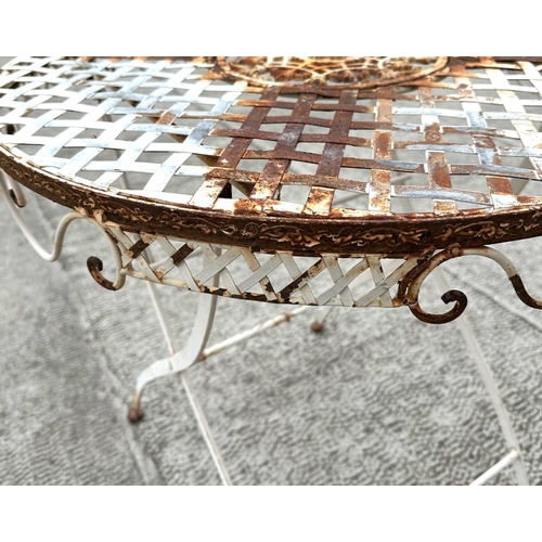 21 - A folding circular white painted metal garden table, with lattice work top, 69cm diameter.
