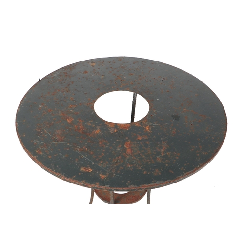 30 - A well weathered painted metal garden table, with central hole holding a plant pot, 70cm diameter.