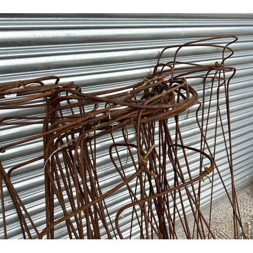 32 - A quantity of well weathered garden flower supports.
