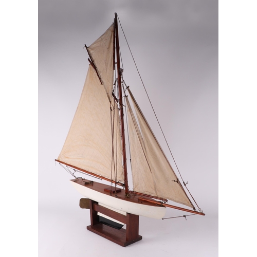 374 - A pond yacht, having a painted hull, 72cm long, mounted on a stand.