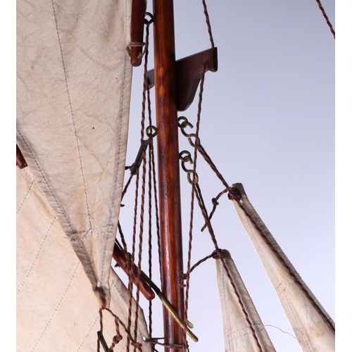 374 - A pond yacht, having a painted hull, 72cm long, mounted on a stand.