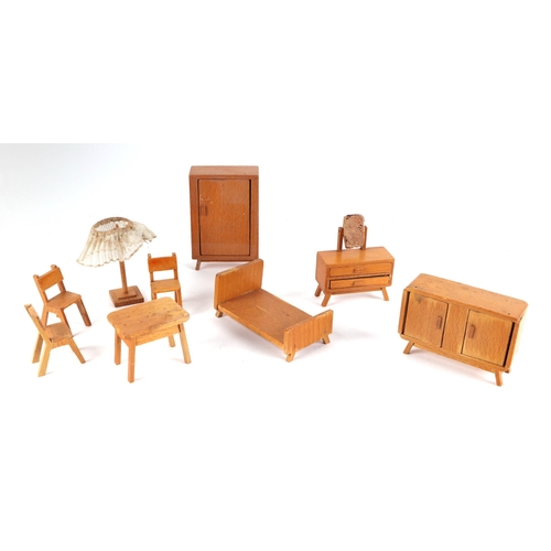375 - A 1930s Tri-Ang doll's house with a selection of doll's house furniture, 36cm wide.