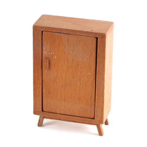 375 - A 1930s Tri-Ang doll's house with a selection of doll's house furniture, 36cm wide.