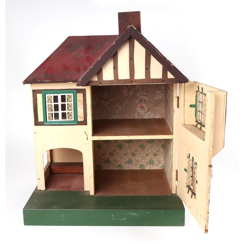 375 - A 1930s Tri-Ang doll's house with a selection of doll's house furniture, 36cm wide.