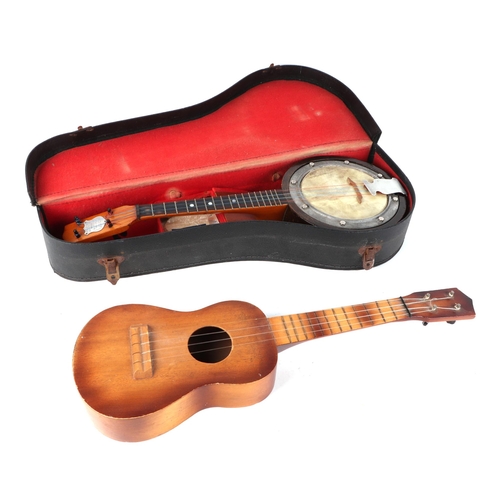 378 - A Swanee banjo ukulele, cased, 53cm long, with modern guitar shaped ukulele (2).