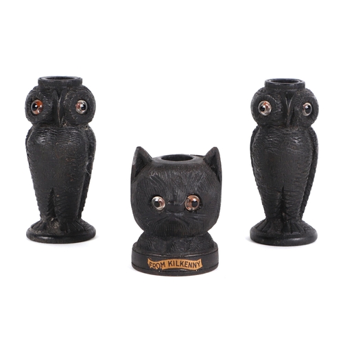 380 - A pair of Irish carved bog oak needle / bobbin holders, in the form of owls, 8cm high, and another i... 