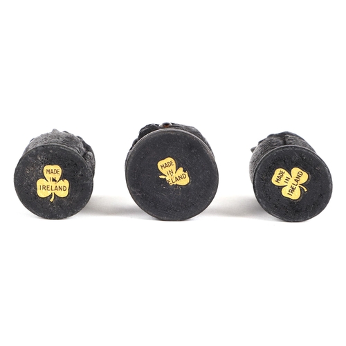 380 - A pair of Irish carved bog oak needle / bobbin holders, in the form of owls, 8cm high, and another i... 