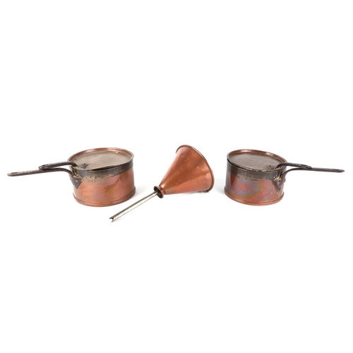 384 - A pair of copper pans and covers, 20cm diameter, and a copper funnel, 16cm diameter (3).