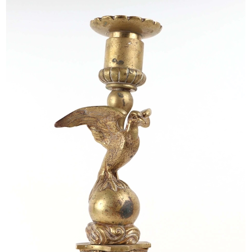 393 - A pair of French brass Empire style candlesticks with eagle perched on bull sconces, Corinthian colu... 