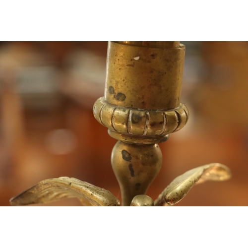 393 - A pair of French brass Empire style candlesticks with eagle perched on bull sconces, Corinthian colu... 