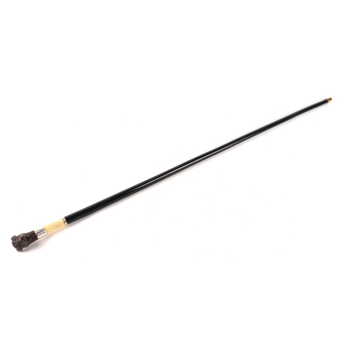 397 - A Victorian ebonised walking cane, with silver collar and ivory section, having a carved soft wood m... 