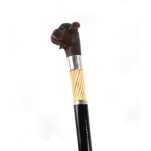 397 - A Victorian ebonised walking cane, with silver collar and ivory section, having a carved soft wood m... 