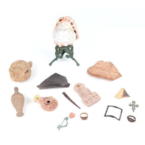 403 - Antiquities. A group of bronze and pottery artefacts, together with a carved cameo shell lamp.