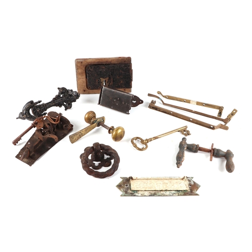 409 - A collection of Georgian and Victorian door furniture, including coffer lock and key, door knocker, ... 