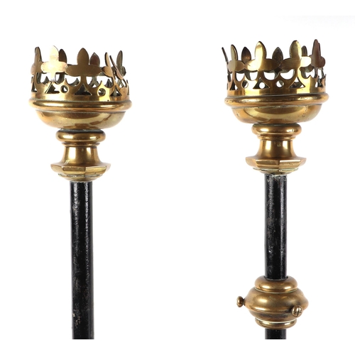 412 - A pair of gothic revival brass and iron candle sticks, on oak bases, 63cm high (2).