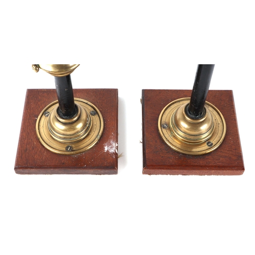 412 - A pair of gothic revival brass and iron candle sticks, on oak bases, 63cm high (2).