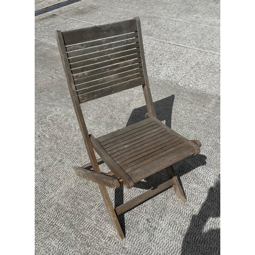 42 - A teak refectory style garden table, having a rectangular top, on trestle type supports, 180cm long,... 