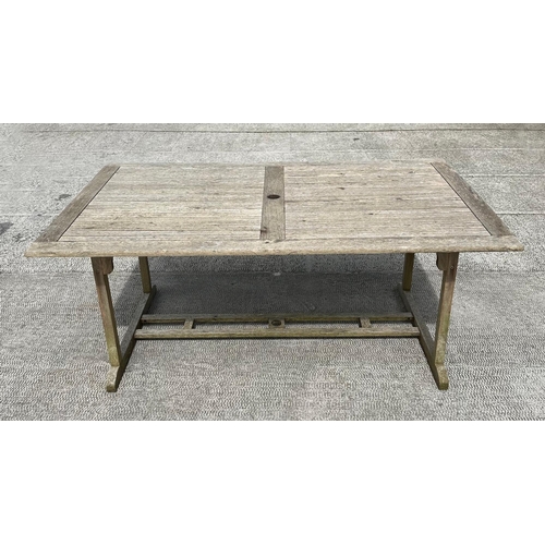 42 - A teak refectory style garden table, having a rectangular top, on trestle type supports, 180cm long,... 