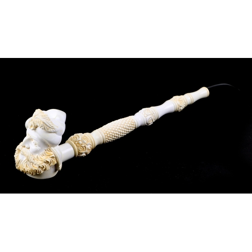 421 - A large two piece meerschaum pipe in the form of a bearded man, overall 42cm long, cased.