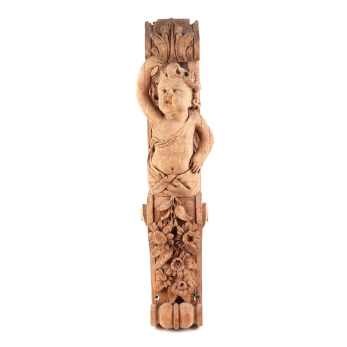 440 - A carved oak corbel, in the form of a putti, possible 18th century, 65cm high, and a pine pineapple ... 
