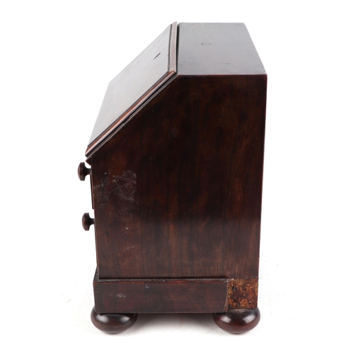 458 - A 19th century rosewood apprentice piece in the form of a bureau , the fall front enclosing four sho... 