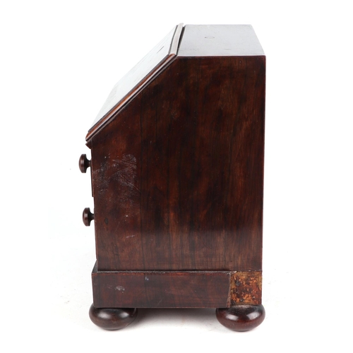 458 - A 19th century rosewood apprentice piece in the form of a bureau , the fall front enclosing four sho... 