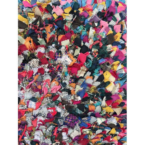 129 - An early 20th century rag rug, 130 by 95cm.