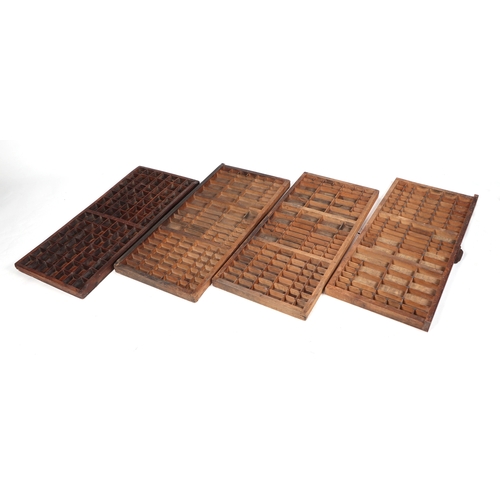 390 - Four vintage printer type set trays, each 82cm wide (4).