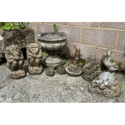 12 - A well weathered stoneware planter, 39cms wide; together with a group of garden ornaments.