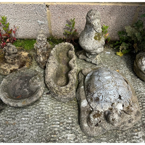 12 - A well weathered stoneware planter, 39cms wide; together with a group of garden ornaments.