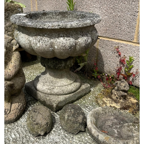 12 - A well weathered stoneware planter, 39cms wide; together with a group of garden ornaments.