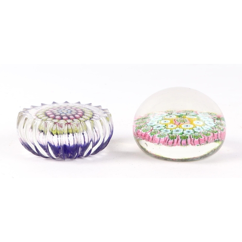 164 - A Baccarat style paperweight with floral canes, 6cms diameter; together with another similar, 6cms d... 