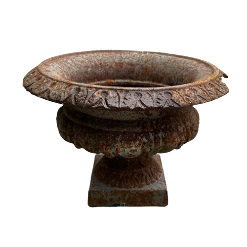 17 - A Neo-classical style cast iron urn, 29cms diameter (chip to rim); together with a strapwork metal s... 