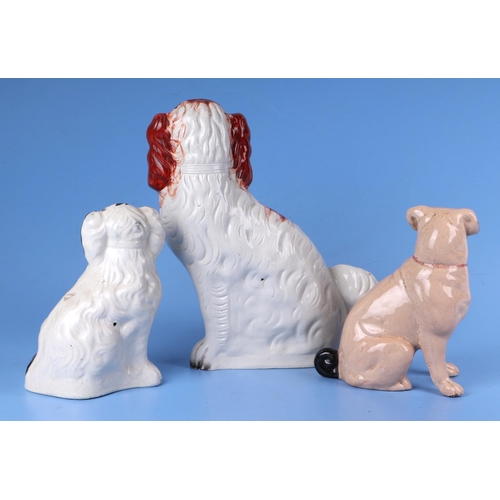 212 - A Staffordshire spaniel dog, 30cms high; together with another, 20cms high and a pottery figure of a... 