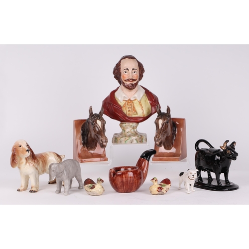 234 - A quantity of assorted ceramics to include a bust of William Shakespeare; a pair of horse head booke... 