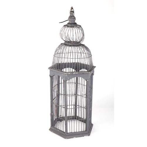 269 - A decorative painted wooden bird cage, 71cms high.