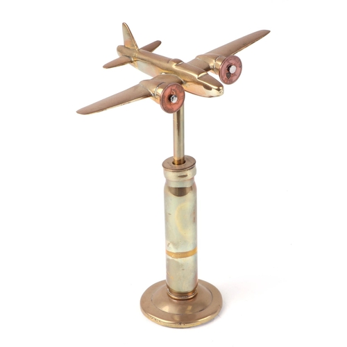 29 - A trench art cast brass model of a Wellington Bomber, mounted on a brass plinth, wingspan 17cm.