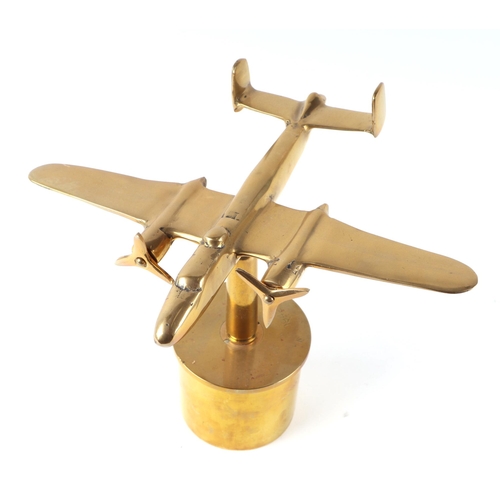 32 - A trench art cast brass model of a Mitchell aircraft, mounted on a brass shell case, 27cm diameter.