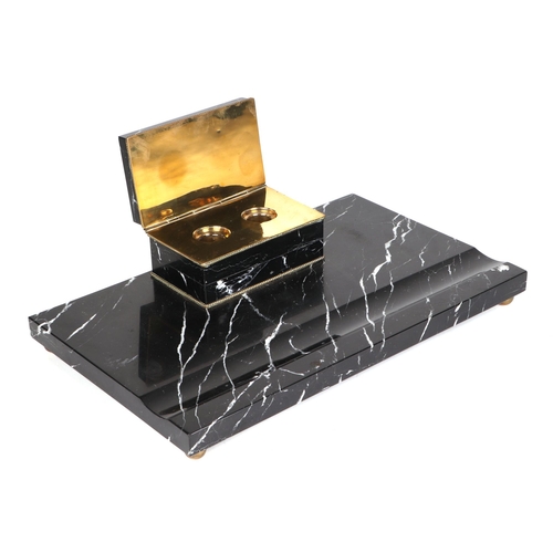 320 - An Art Deco black marble pen & ink stand with pen well and surmounted two division inkwell, on brass... 