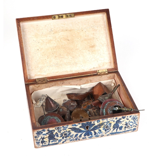 326 - An Iznik type wooden box with traditional decoration containing a small collection of copper miniatu... 