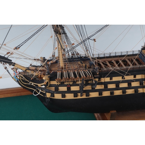 327 - A large scratch built model of HMS Victory in a glass display case, the model approx 102cms long, th... 