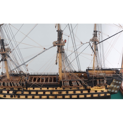 327 - A large scratch built model of HMS Victory in a glass display case, the model approx 102cms long, th... 