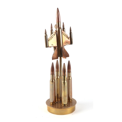 33 - A trench art cast brass model of a Jet aircraft, constructed from brass bullets, mounted on a brass ... 