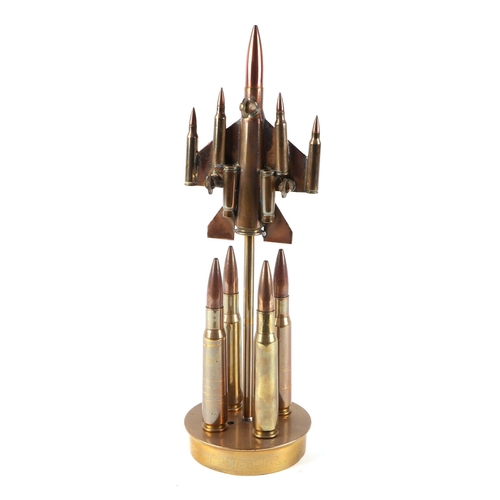 33 - A trench art cast brass model of a Jet aircraft, constructed from brass bullets, mounted on a brass ... 