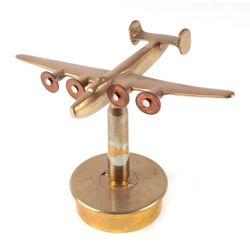 34 - A trench art cast brass model of Wellington Bomber, mounted on a brass shell case, wingspan 22cm.