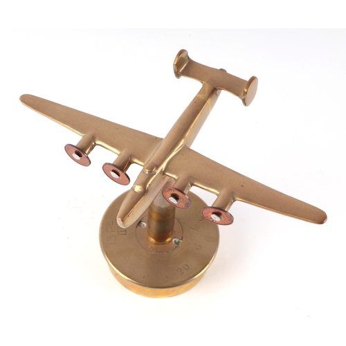 34 - A trench art cast brass model of Wellington Bomber, mounted on a brass shell case, wingspan 22cm.