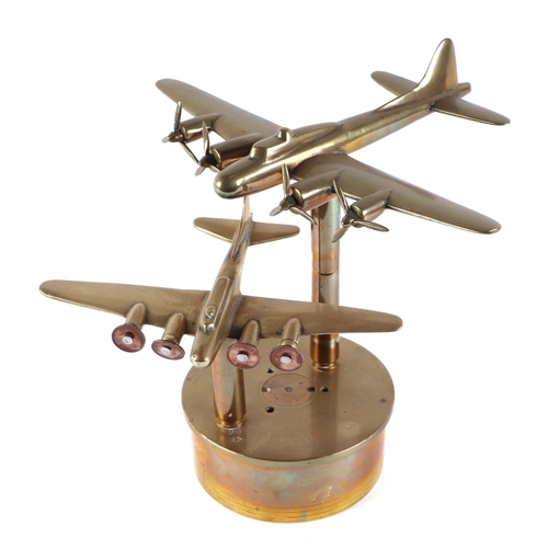 35 - A trench art brass pair of Flying Fortress Bombers, mounted on a brass artillery shell base, wingspa... 