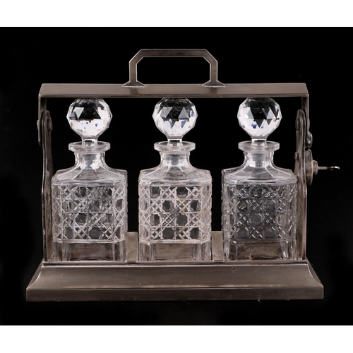 363 - A 20th century silver plated Tantalus with three cut glass decanters and stoppers. 34cm wide